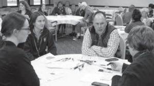 Alderman O'Shea speaking with group at a table