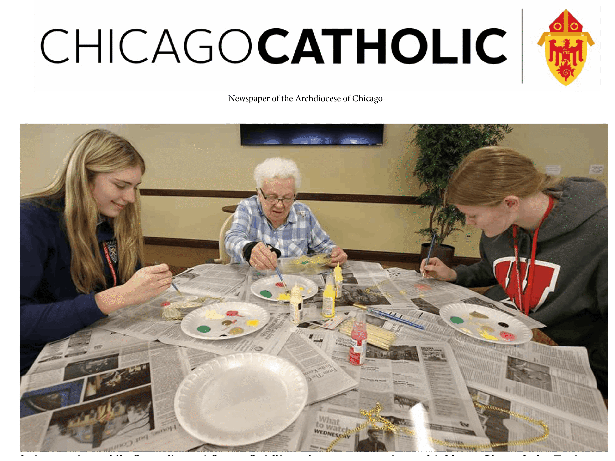 Mercy Circle resident sitting with McAuley students doing crafts