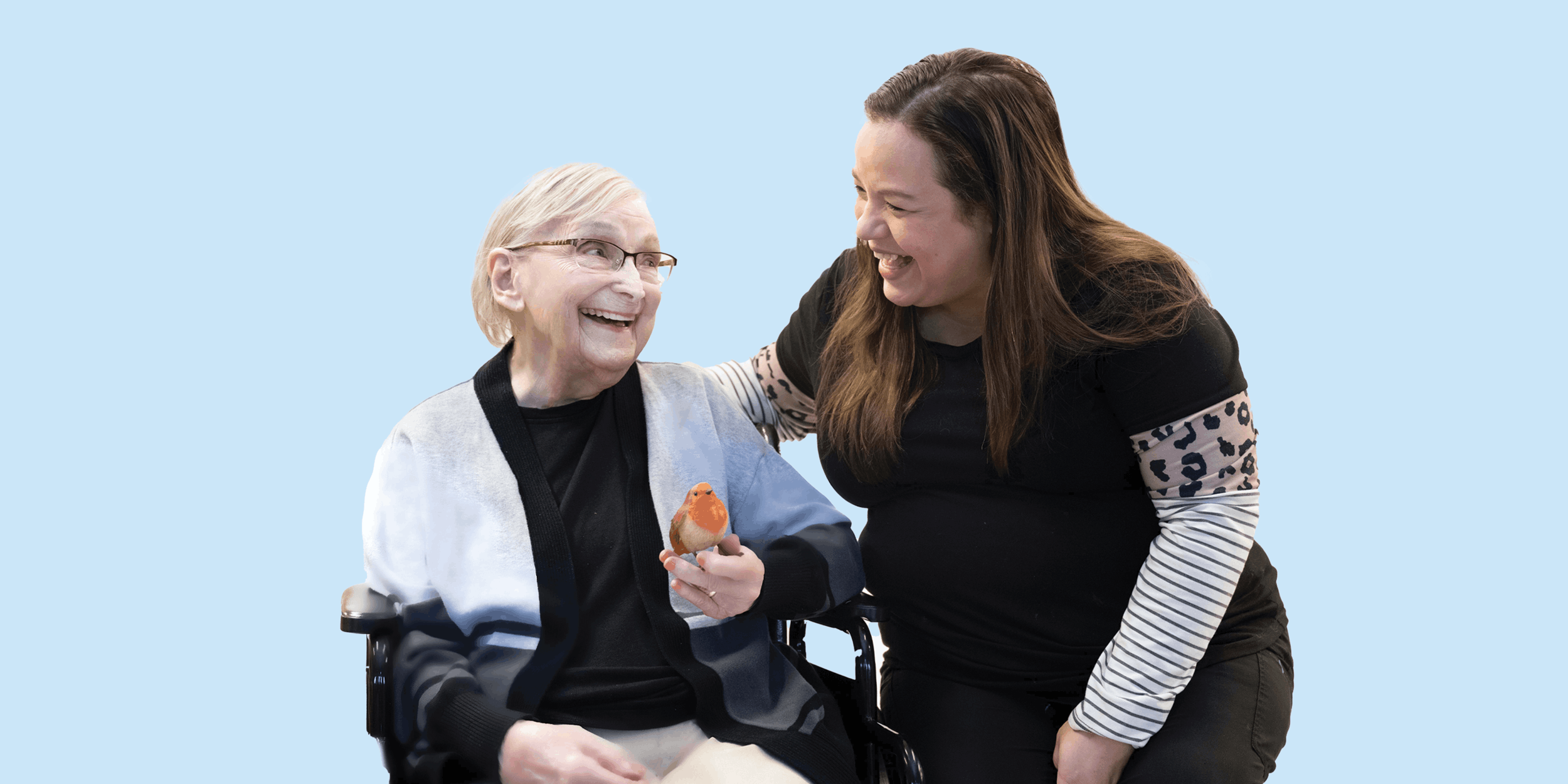 Nurse with resident holding a small bird