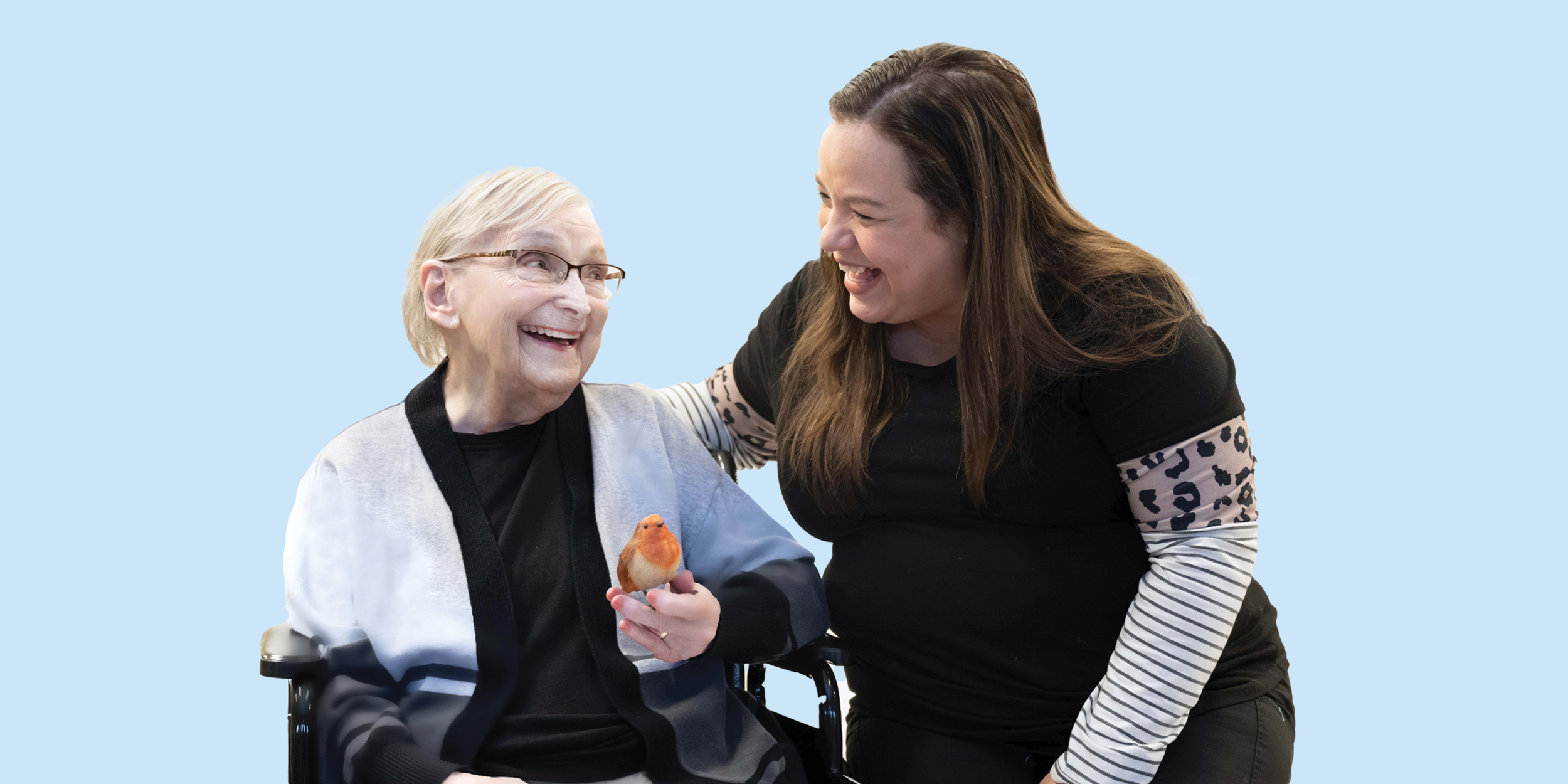 Nurse with resident holding a small bird