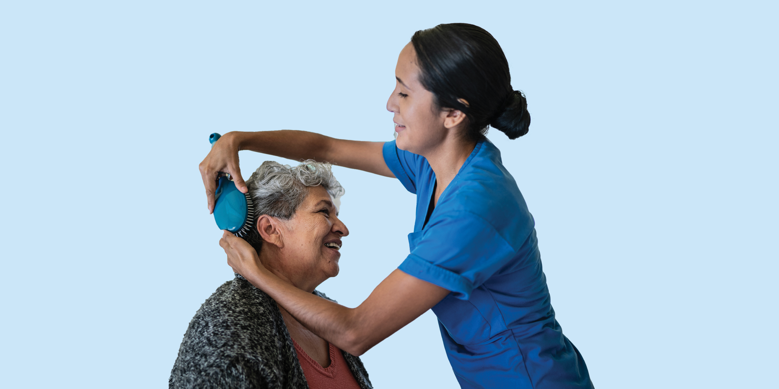 Nurse brushing a female resident's hair